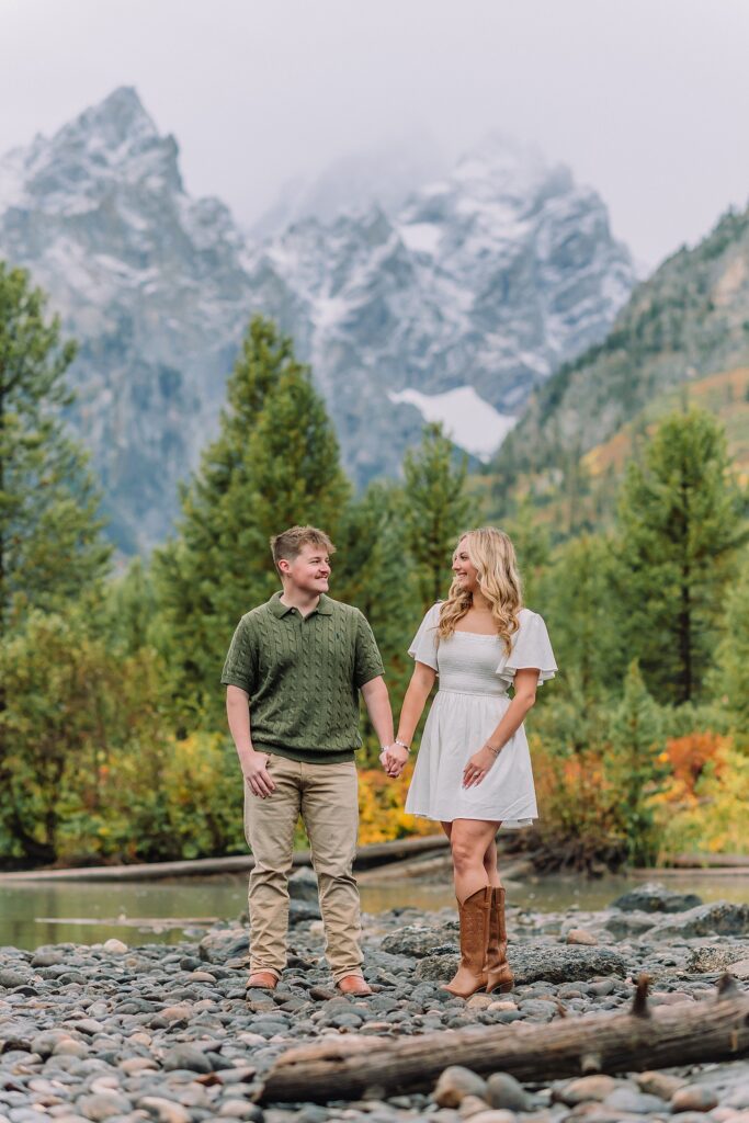 String Lake fall engagement photos Grand Teton National Park Rainy day engagement photos Grand Teton National Park fall Fall colors engagement session String Lake Wyoming mountains Couple getting engaged with Teton mountain peaks in background jackson hole engagement photographer