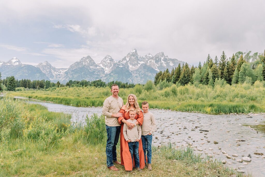 family photos at Schwabacher Landing Grand Teton National Park summer family photography session in Jackson Hole Wyoming coordinated outfit ideas for family photos in the mountains rust dress family photos with mountain backdrop