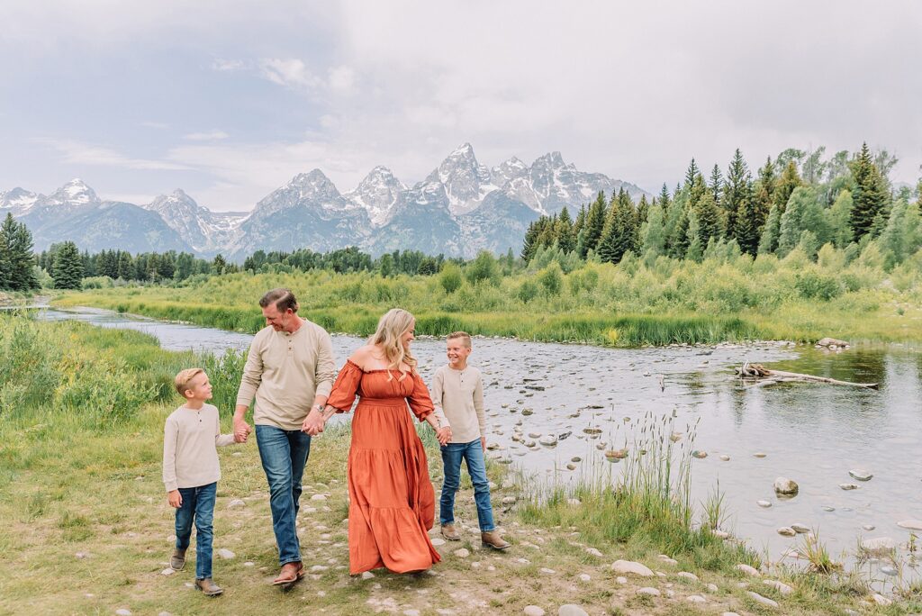 family photos at Schwabacher Landing Grand Teton National Park summer family photography session in Jackson Hole Wyoming coordinated outfit ideas for family photos in the mountains rust dress family photos with mountain backdrop