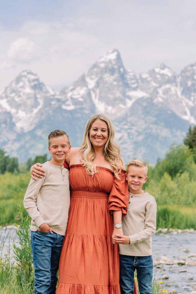 family photos at Schwabacher Landing Grand Teton National Park summer family photography session in Jackson Hole Wyoming coordinated outfit ideas for family photos in the mountains rust dress family photos with mountain backdrop