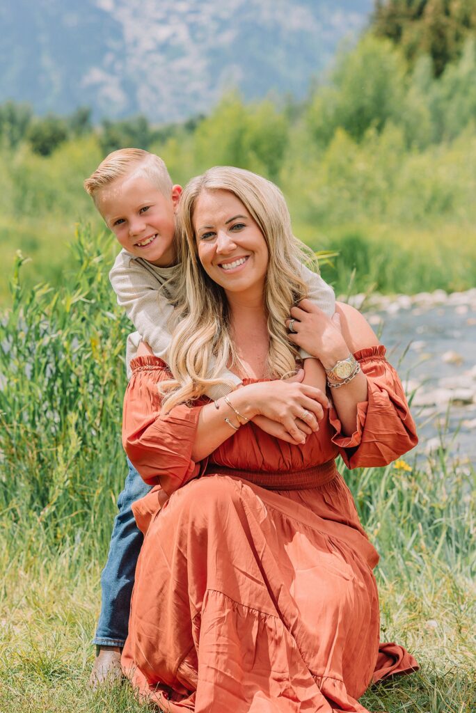 family photos at Schwabacher Landing Grand Teton National Park summer family photography session in Jackson Hole Wyoming coordinated outfit ideas for family photos in the mountains rust dress family photos with mountain backdrop