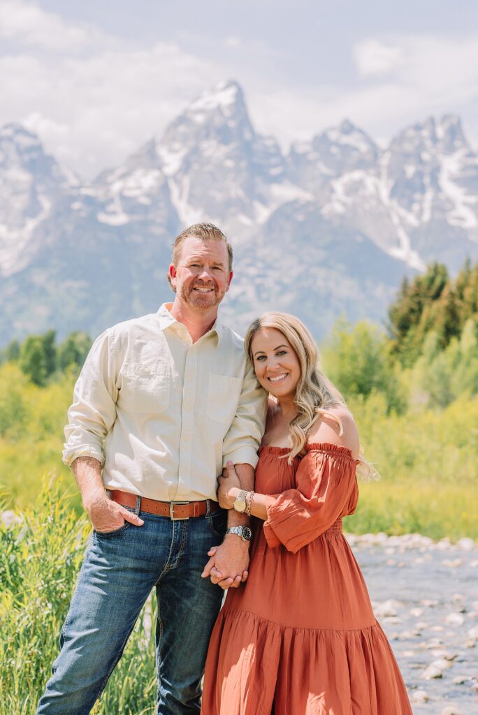 summer family photography session in Jackson Hole Wyoming coordinated outfit ideas for family photos in the mountains rust dress family photos with mountain backdrop boys posing naturally during Grand Teton photography session