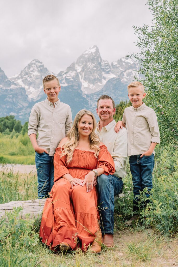 family playing in water during professional photo session Grand Teton sunrise family portraits at Schwabacher Landing cream and rust color palette mountain family photos Grand Teton vacation photographer coordinating family outfits without matching