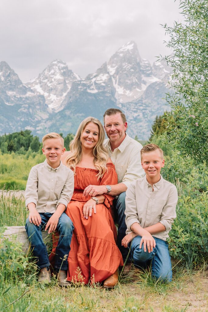 family playing in water during professional photo session Grand Teton sunrise family portraits at Schwabacher Landing cream and rust color palette mountain family photos Grand Teton vacation photographer coordinating family outfits without matching