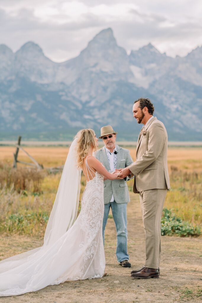 Mormon Row Grand Teton wedding ceremony cathedral veil alpine wedding photography fall colors Grand Teton elopement intimate outdoor micro wedding Wyoming champagne toast Grand Teton wedding celebration semi-formal outdoor alpine wedding attire first look Mormon Row Grand Tetons