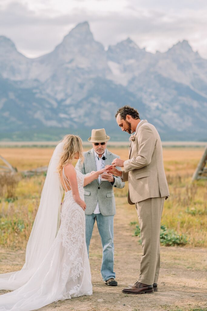Mormon Row Grand Teton wedding ceremony cathedral veil alpine wedding photography fall colors Grand Teton elopement intimate outdoor micro wedding Wyoming champagne toast Grand Teton wedding celebration semi-formal outdoor alpine wedding attire first look Mormon Row Grand Tetons