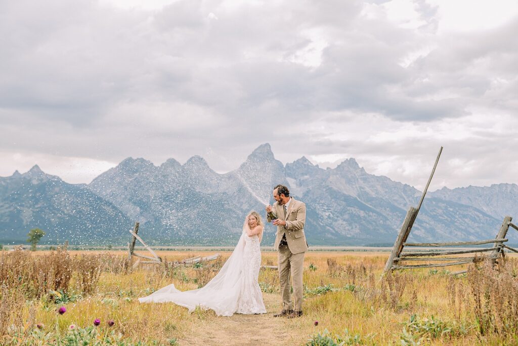 Mormon Row Grand Teton wedding ceremony cathedral veil alpine wedding photography fall colors Grand Teton elopement intimate outdoor micro wedding Wyoming champagne toast Grand Teton wedding celebration semi-formal outdoor alpine wedding attire first look Mormon Row Grand Tetons
