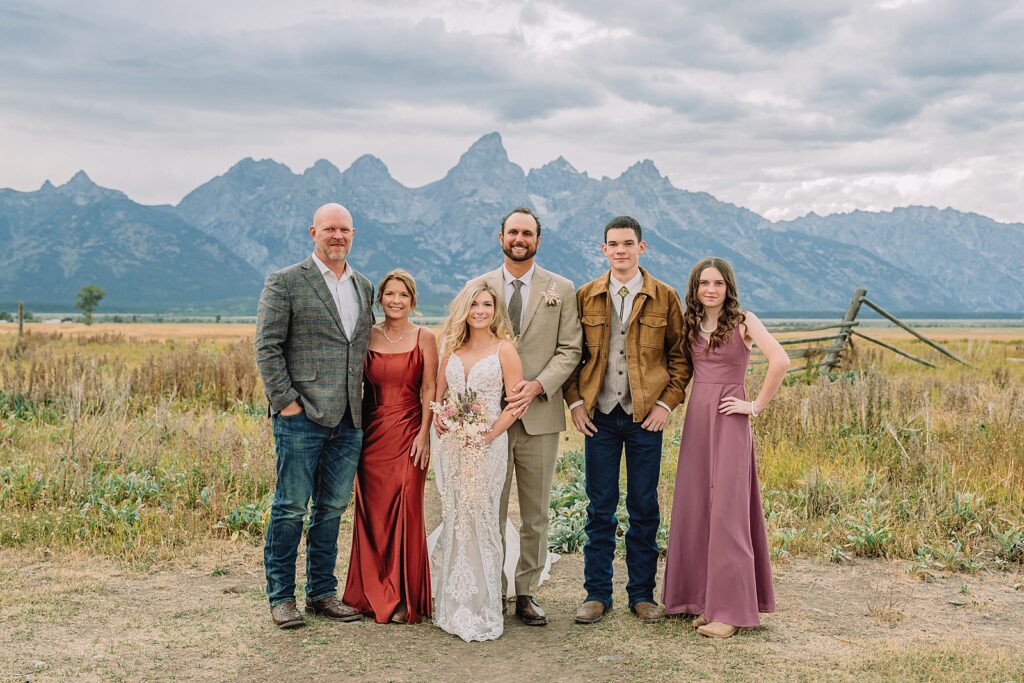 Mormon Row Grand Teton wedding ceremony cathedral veil alpine wedding photography fall colors Grand Teton elopement intimate outdoor micro wedding Wyoming champagne toast Grand Teton wedding celebration semi-formal outdoor alpine wedding attire first look Mormon Row Grand Tetons