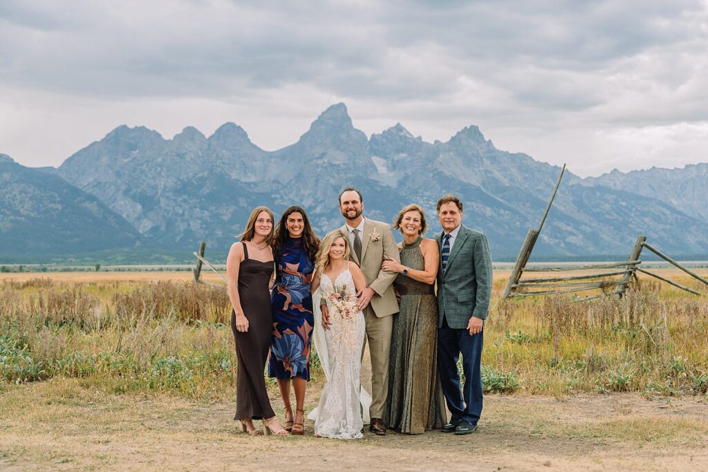 Mormon Row Grand Teton wedding ceremony cathedral veil alpine wedding photography fall colors Grand Teton elopement intimate outdoor micro wedding Wyoming champagne toast Grand Teton wedding celebration semi-formal outdoor alpine wedding attire first look Mormon Row Grand Tetons