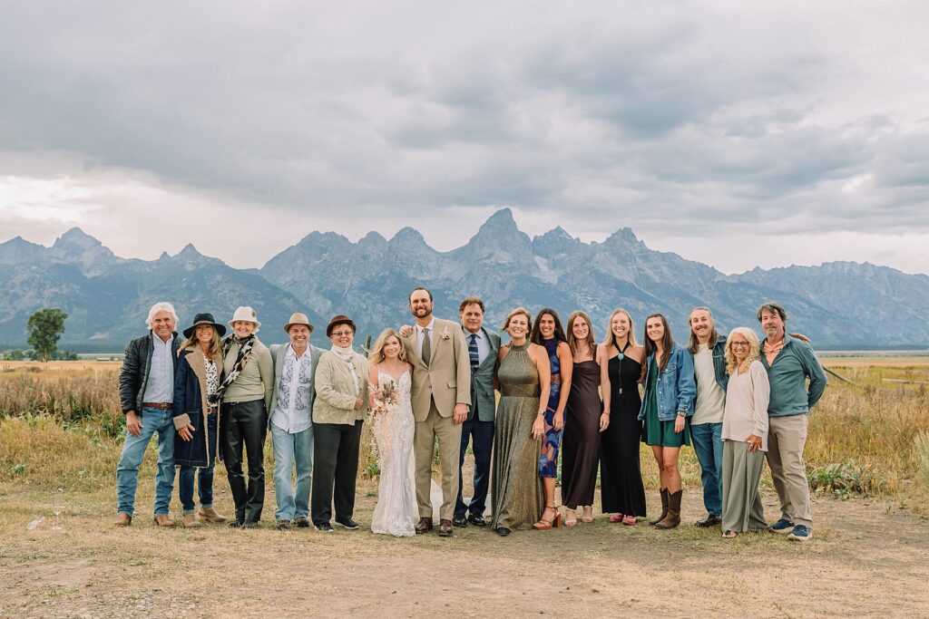 Mormon Row Grand Teton wedding ceremony cathedral veil alpine wedding photography fall colors Grand Teton elopement intimate outdoor micro wedding Wyoming champagne toast Grand Teton wedding celebration semi-formal outdoor alpine wedding attire first look Mormon Row Grand Tetons