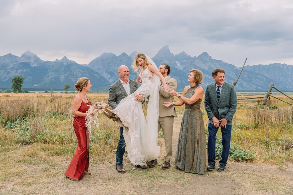 Mormon Row Grand Teton wedding ceremony cathedral veil alpine wedding photography fall colors Grand Teton elopement intimate outdoor micro wedding Wyoming champagne toast Grand Teton wedding celebration semi-formal outdoor alpine wedding attire first look Mormon Row Grand Tetons