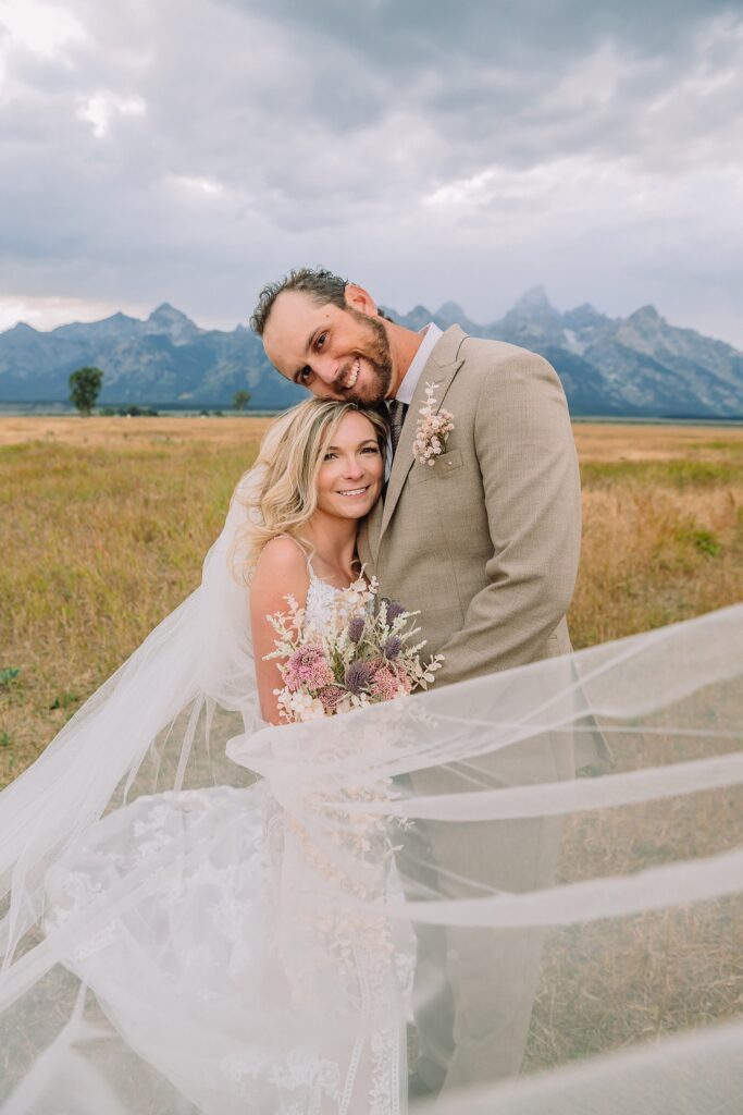 Mormon Row Grand Teton wedding ceremony cathedral veil alpine wedding photography fall colors Grand Teton elopement intimate outdoor micro wedding Wyoming champagne toast Grand Teton wedding celebration semi-formal outdoor alpine wedding attire first look Mormon Row Grand Tetons