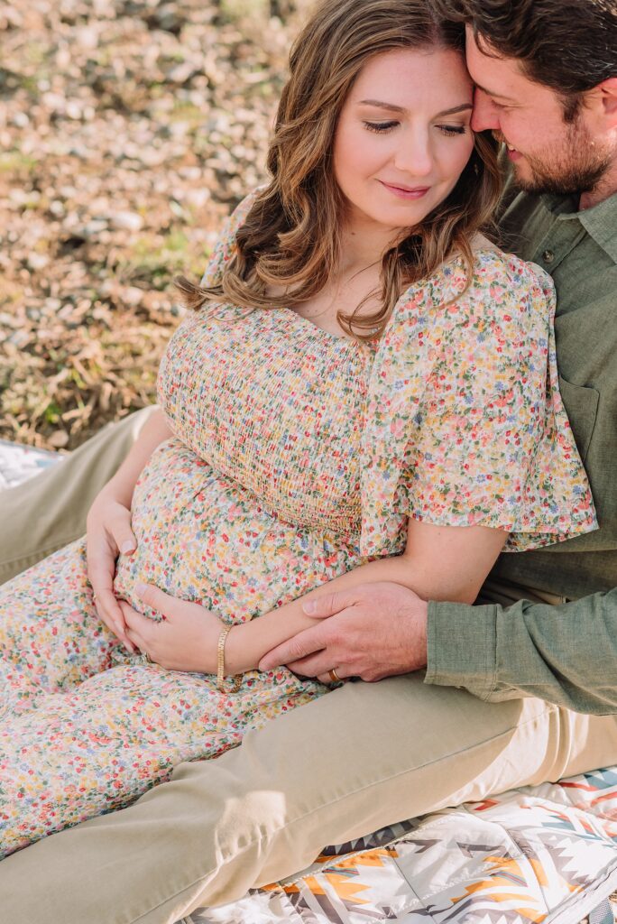 Jackson Hole babymoon maternity photos at Cathedral View Turnout Grand Teton National Park maternity session in spring Cathedral View Turnout couple photos snow capped peaks Flowery maternity dress mountain photography Jackson Hole Jackson Hole Maternity Photographer