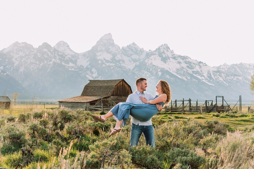 golden hour couples photography Mormon Row Jackson Hole Teton mountain backdrop engagement photos Wyoming blue coordinated outfits couples portraits Grand Tetons historic barn couples photography Jackson Hole Wyoming spring aspen trees anniversary session Mormon Row rustic fence line portraits Grand Teton National Park