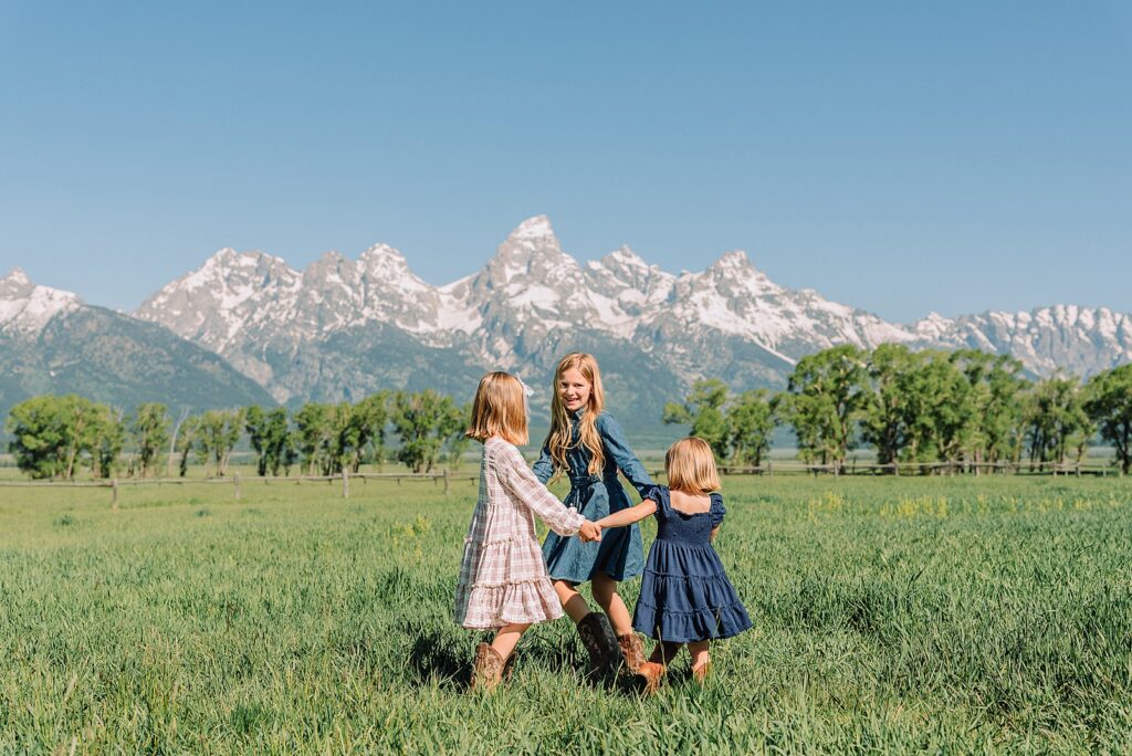 Jackson Hole Family Photos family photos at Mormon Row Wyoming Teton Range family portraits with historic barn Mormon Row south barn family pictures rustic barn backdrop family portraits Wyoming