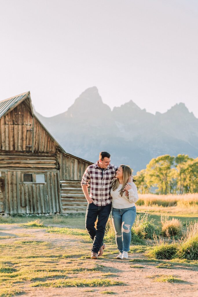 Mormon Row barn proposal photography Jackson Hole Wyoming Sunset engagement photos at TA Moulton Barn Surprise proposal photographer Grand Teton National Park Golden hour mountain proposal photography Jackson Hole Authentic couple portraits Mormon Row historic barn