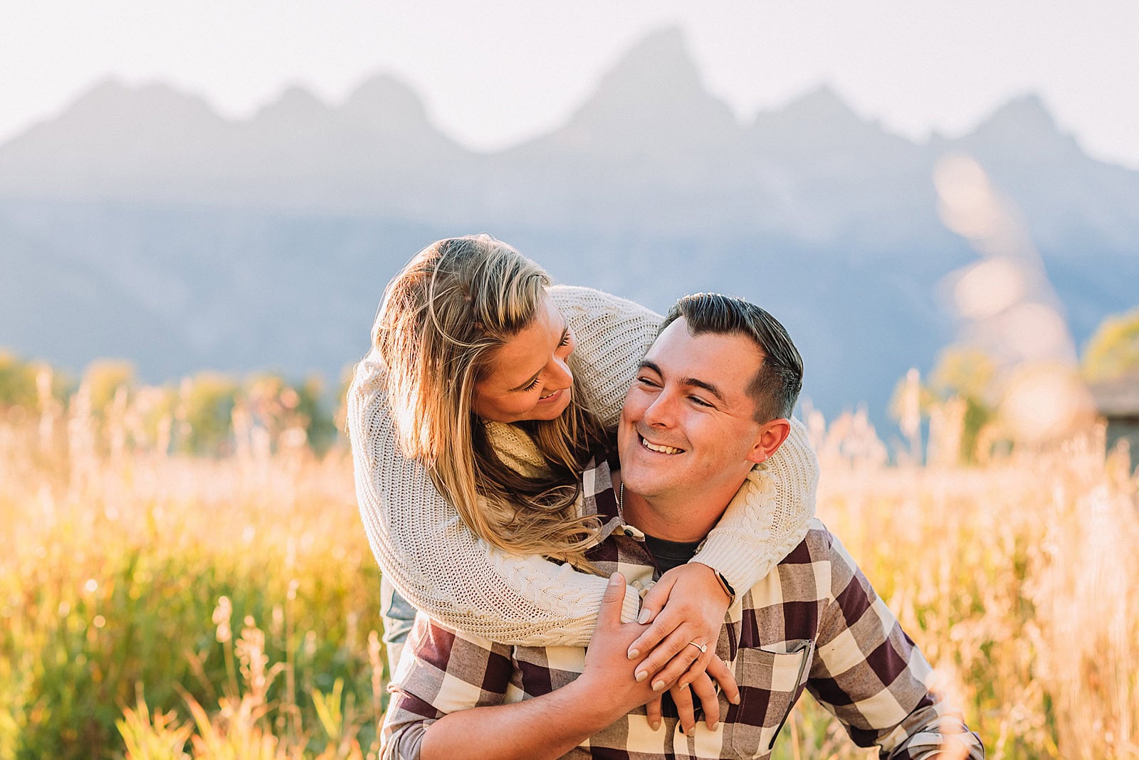 Authentic couple portraits Mormon Row historic barn Jackson Hole mountain engagement session summer sunset Candid proposal moment Teton mountain backdrop photography Romantic Wyoming barn proposal photos golden light