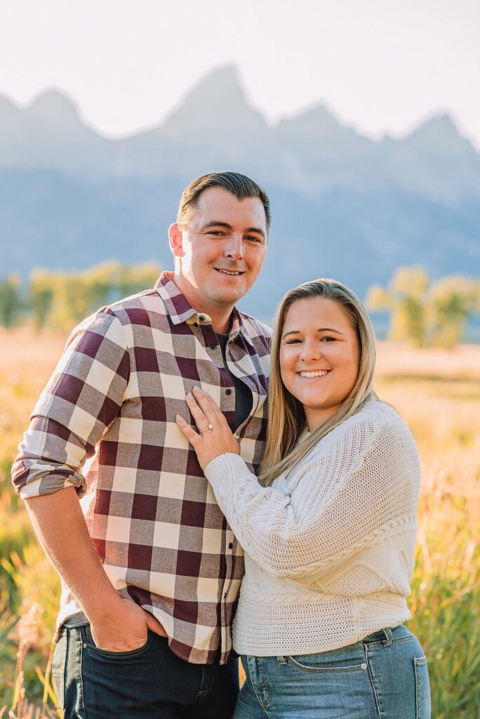 Golden hour mountain proposal photography Jackson Hole Authentic couple portraits Mormon Row historic barn Jackson Hole mountain engagement session summer sunset Candid proposal moment Teton mountain backdrop photography Romantic Wyoming barn proposal photos golden light