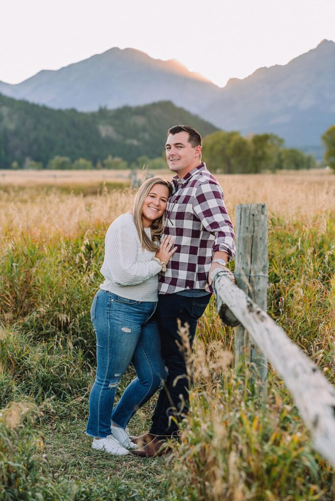Golden hour mountain proposal photography Jackson Hole Authentic couple portraits Mormon Row historic barn Jackson Hole mountain engagement session summer sunset Candid proposal moment Teton mountain backdrop photography Romantic Wyoming barn proposal photos golden light
