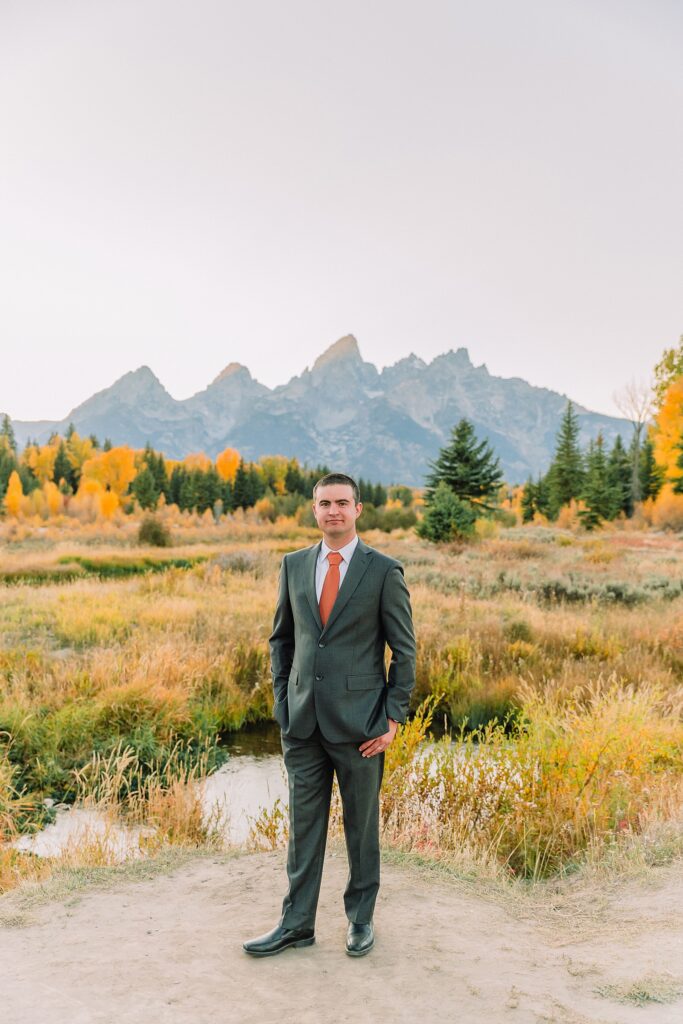 fall bridal portraits at Schwabacher Landing Jackson Hole Grand Teton National Park engagement photos String Lake bride in lace wedding dress with mountain backdrop Wyoming Schwabacher Landing fall color wedding photography Jackson Hole couple portraits with Snake River reflection bride and groom in fall foliage Grand Teton Wyoming rust orange tie groom wedding portraits Jackson Hole fall September engagement photos String Lake Teton National Park