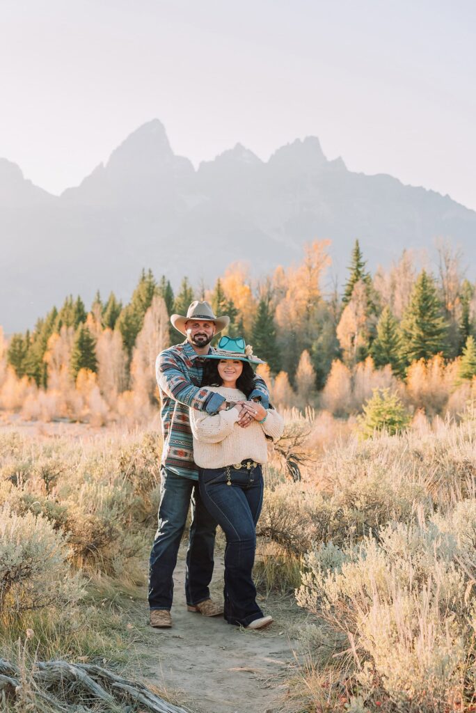 couple wearing custom engraved western hats at Grand Teton elopement turquoise wedding jewelry details at Jackson Hole mountain wedding horseback riding wedding party tour at Spring Creek Ranch Wyoming Schwabacher Landing sunset elopement portraits in Grand Teton National Park casual outfit change for relaxed mountain elopement photos split day wedding coverage for destination elopement couples flexible elopement timeline for Jackson Hole micro wedding western jeans and sweater look for Wyoming vacation style portraits