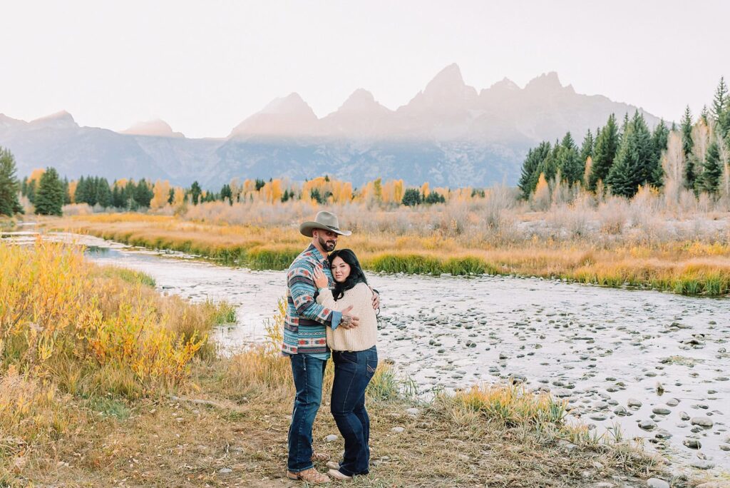 couple wearing custom engraved western hats at Grand Teton elopement turquoise wedding jewelry details at Jackson Hole mountain wedding horseback riding wedding party tour at Spring Creek Ranch Wyoming Schwabacher Landing sunset elopement portraits in Grand Teton National Park casual outfit change for relaxed mountain elopement photos split day wedding coverage for destination elopement couples flexible elopement timeline for Jackson Hole micro wedding western jeans and sweater look for Wyoming vacation style portraits