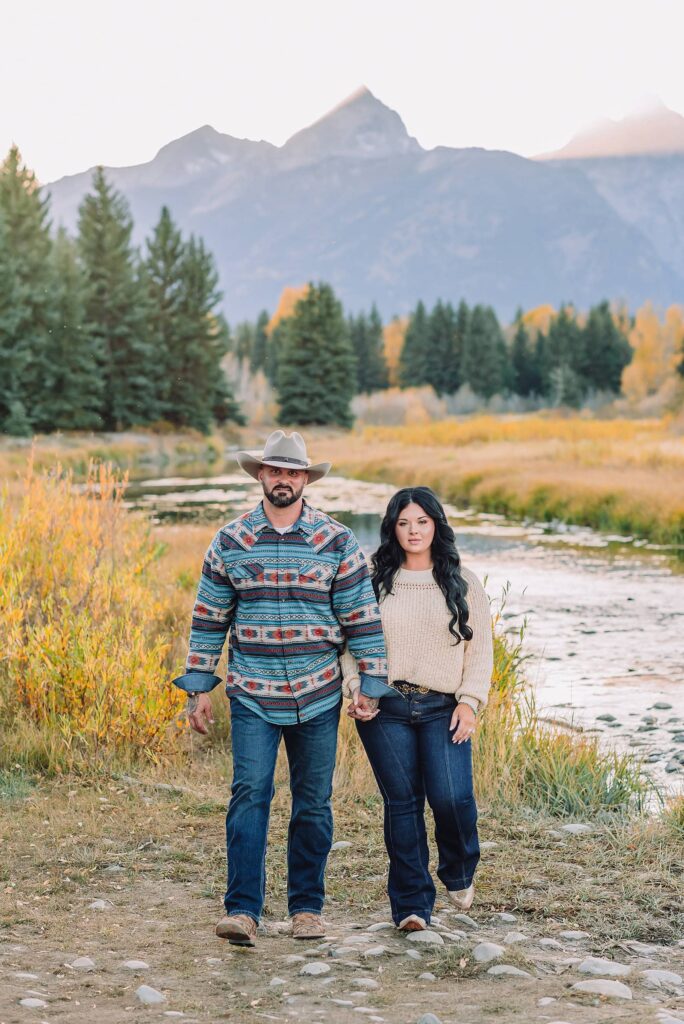 couple wearing custom engraved western hats at Grand Teton elopement turquoise wedding jewelry details at Jackson Hole mountain wedding horseback riding wedding party tour at Spring Creek Ranch Wyoming Schwabacher Landing sunset elopement portraits in Grand Teton National Park casual outfit change for relaxed mountain elopement photos split day wedding coverage for destination elopement couples flexible elopement timeline for Jackson Hole micro wedding western jeans and sweater look for Wyoming vacation style portraits