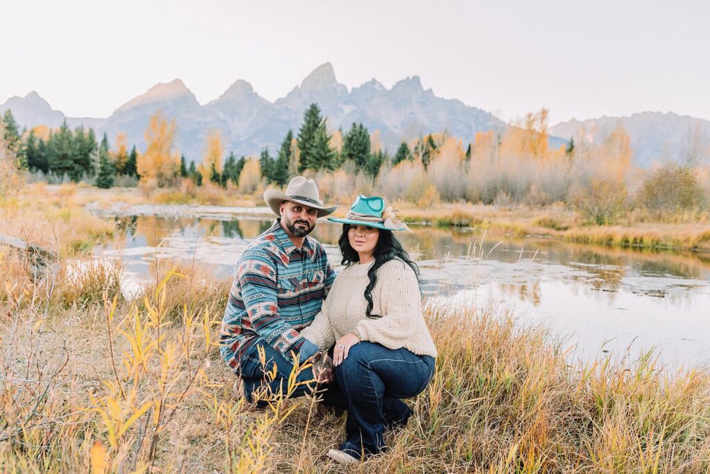 couple wearing custom engraved western hats at Grand Teton elopement turquoise wedding jewelry details at Jackson Hole mountain wedding horseback riding wedding party tour at Spring Creek Ranch Wyoming Schwabacher Landing sunset elopement portraits in Grand Teton National Park casual outfit change for relaxed mountain elopement photos split day wedding coverage for destination elopement couples flexible elopement timeline for Jackson Hole micro wedding western jeans and sweater look for Wyoming vacation style portraits
