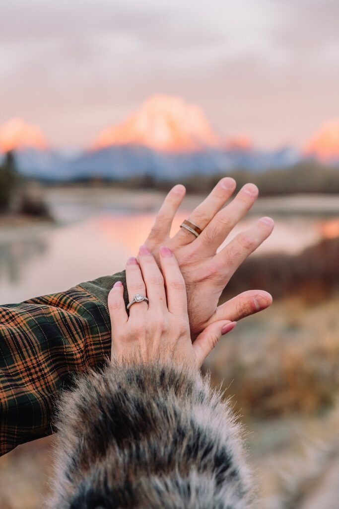 jackson hole anniversary photos at oxbow bend sunrise couple photography with fur coat jackson hole wyoming romantic river shoreline couples portraits grand teton national park october sunrise photography session oxbow bend