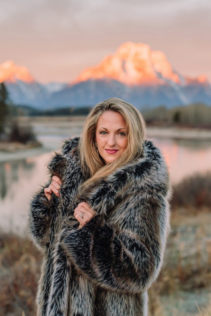 jackson hole anniversary photos at oxbow bend sunrise couple photography with fur coat jackson hole wyoming romantic river shoreline couples portraits grand teton national park october sunrise photography session oxbow bend
