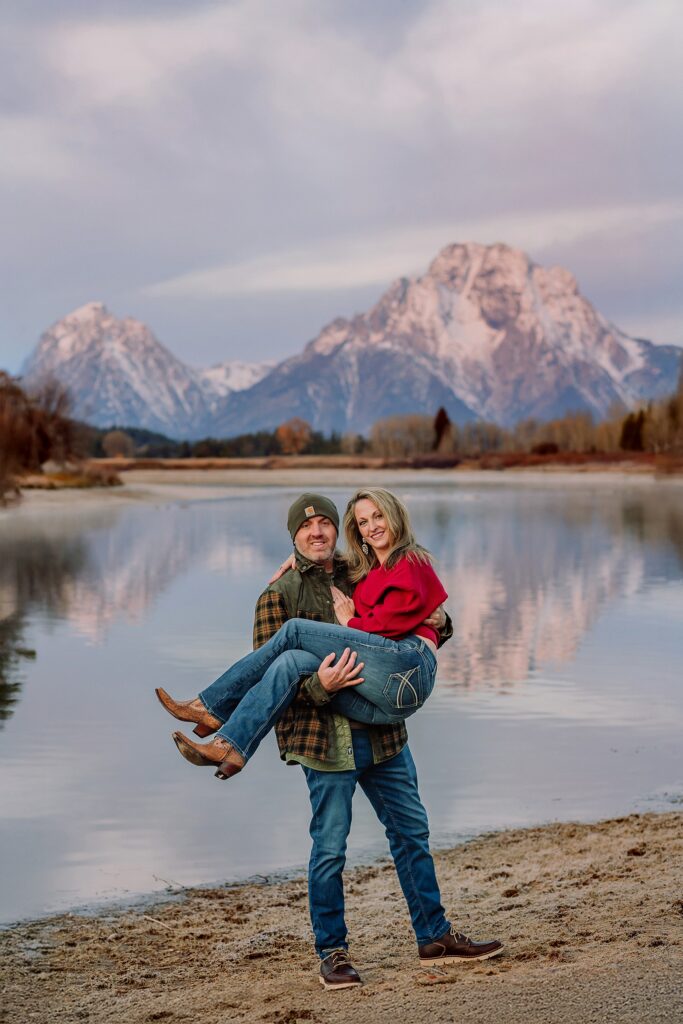 jackson hole anniversary photos at oxbow bend sunrise couple photography with fur coat jackson hole wyoming romantic river shoreline couples portraits grand teton national park october sunrise photography session oxbow bend