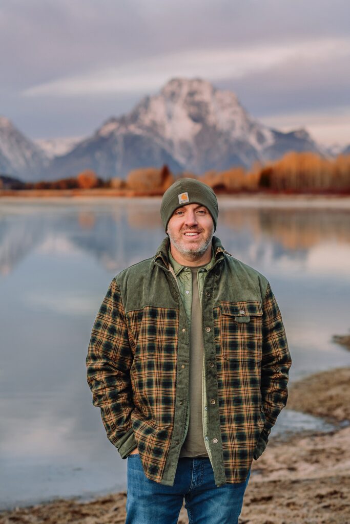 jackson hole anniversary photos at oxbow bend sunrise couple photography with fur coat jackson hole wyoming romantic river shoreline couples portraits grand teton national park october sunrise photography session oxbow bend