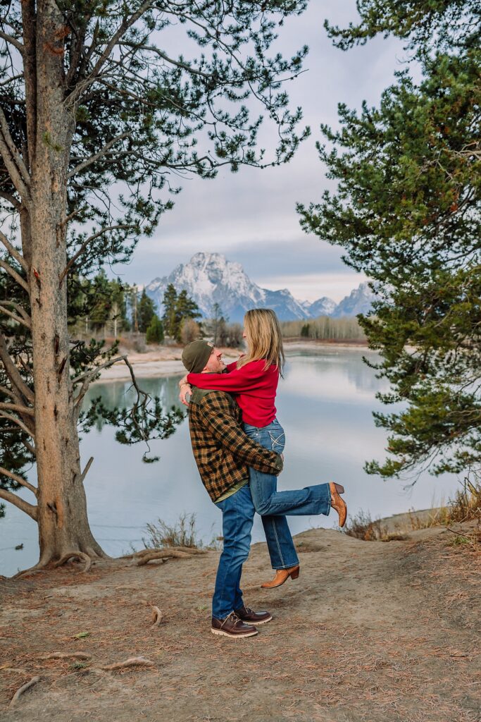 jackson hole anniversary photos at oxbow bend sunrise couple photography with fur coat jackson hole wyoming romantic river shoreline couples portraits grand teton national park october sunrise photography session oxbow bend