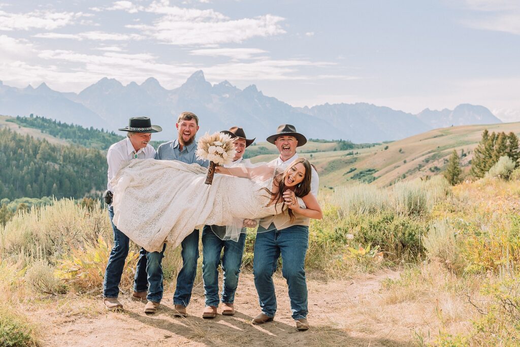 Bridger Teton National Forest outdoor wedding ceremony custom cowboy hat wedding surprise groom gift The Wedding Tree ceremony photos Wyoming champagne toast Grand Teton wedding celebration Jackson Hole Wedding Photographer