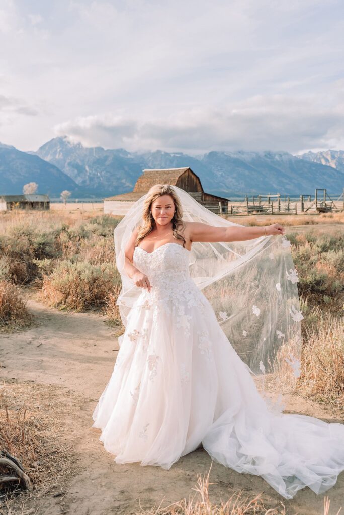 Mormon Row barn elopement photos with Grand Teton mountains fall elopement portraits at Mormon Row historic barns cowboy hat groom Mormon Row wedding photos Schwabacher Landing elopement reflection photos elopement ceremony Jackson Hole