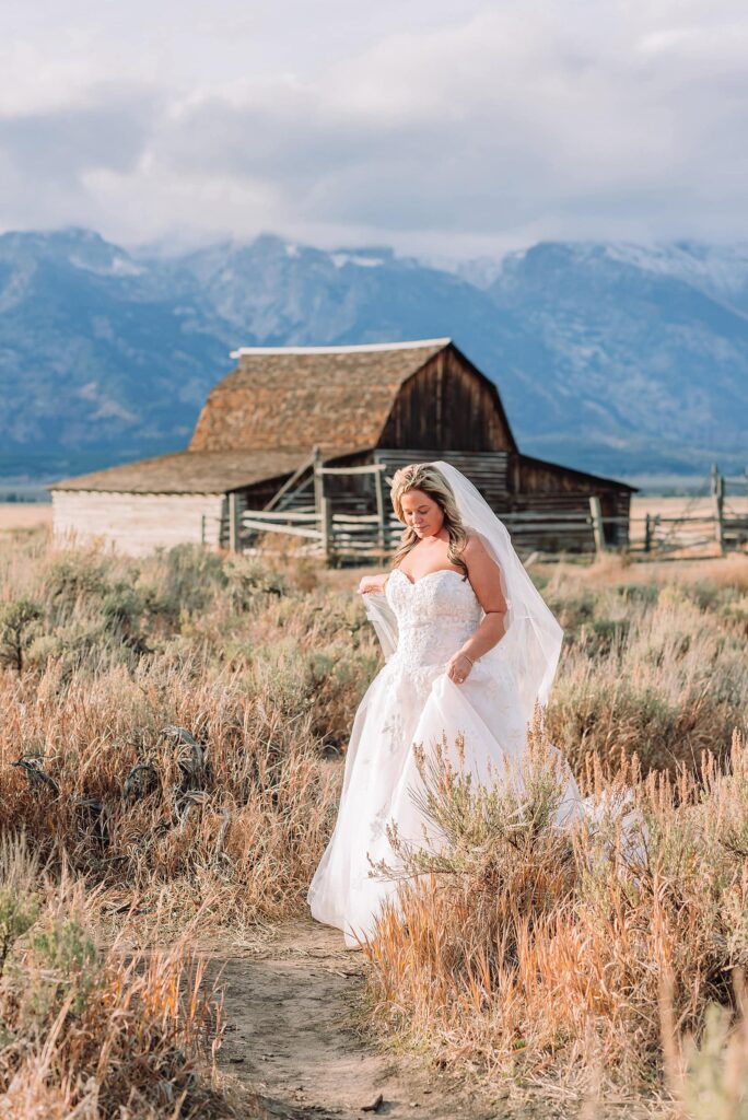 Mormon Row barn elopement photos with Grand Teton mountains fall elopement portraits at Mormon Row historic barns cowboy hat groom Mormon Row wedding photos Schwabacher Landing elopement reflection photos elopement ceremony Jackson Hole
