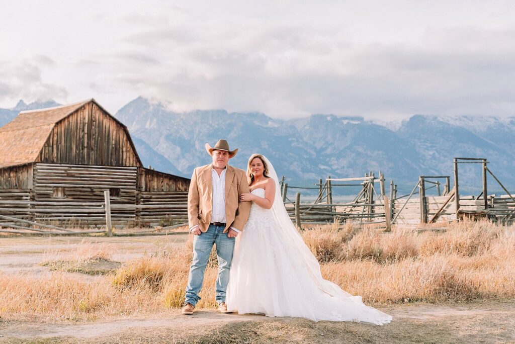 Mormon Row barn elopement photos with Grand Teton mountains fall elopement portraits at Mormon Row historic barns cowboy hat groom Mormon Row wedding photos Schwabacher Landing elopement reflection photos elopement ceremony Jackson Hole
