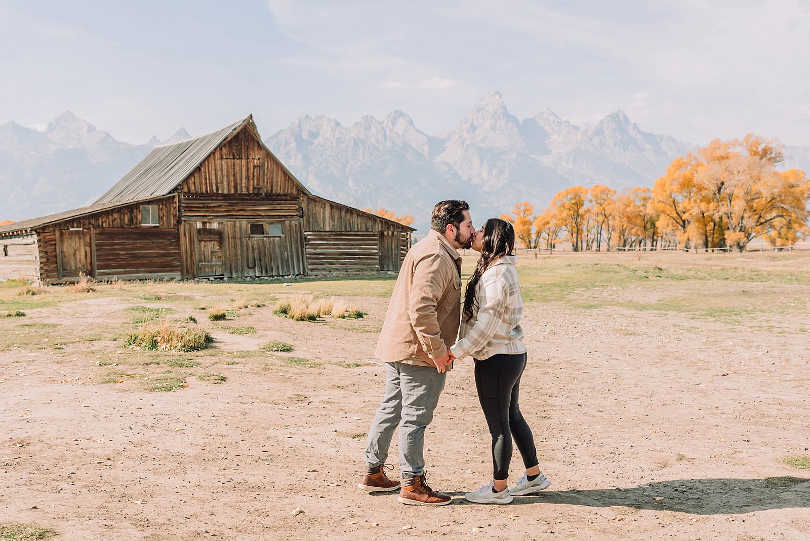 Grand Teton National Park proposal photographer Mormon Row barn proposal photos October proposal session in Jackson Hole surprise proposal at Mormon Row Tetons