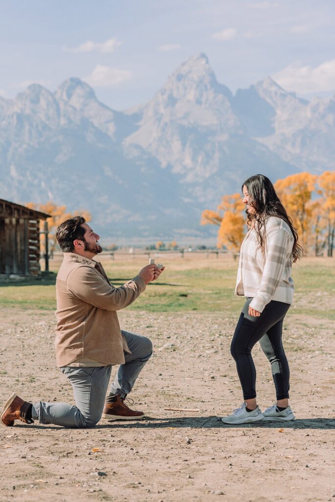 Grand Teton National Park proposal photographer Mormon Row barn proposal photos October proposal session in Jackson Hole surprise proposal at Mormon Row Tetons historic Mormon Row engagement session