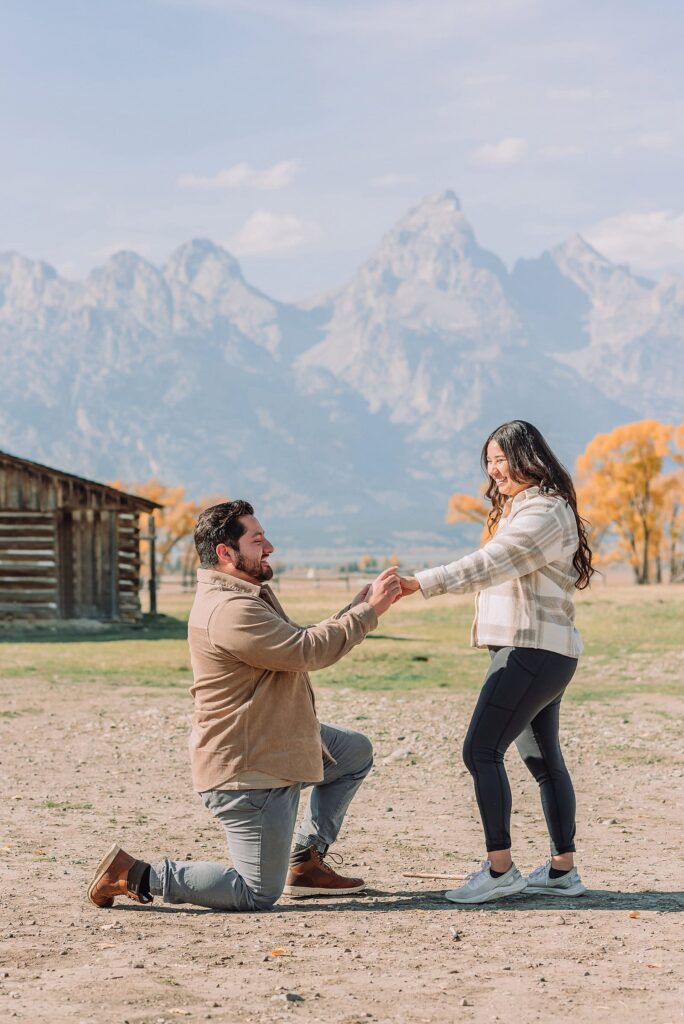Grand Teton National Park proposal photographer Mormon Row barn proposal photos October proposal session in Jackson Hole surprise proposal at Mormon Row Tetons historic Mormon Row engagement session