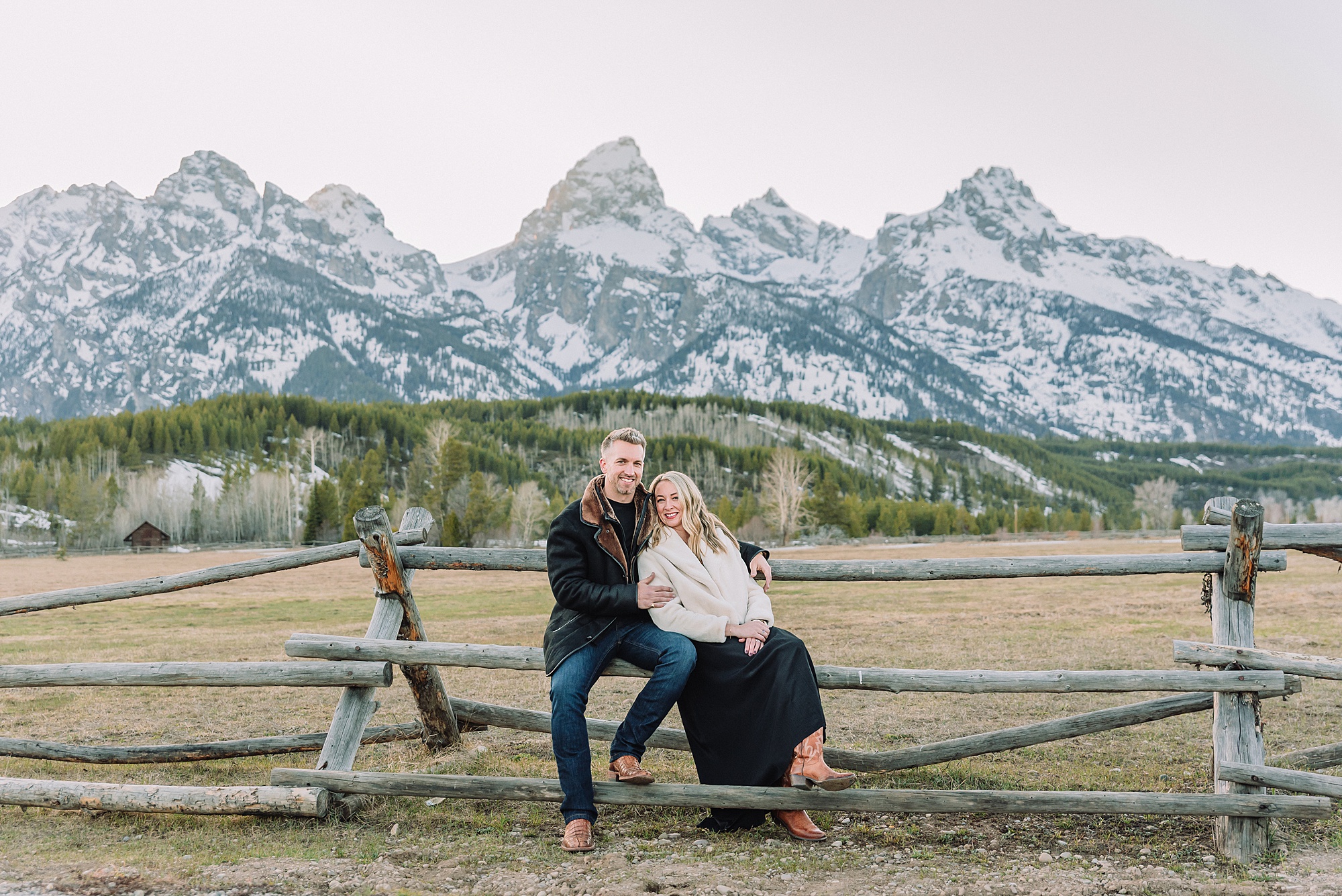 Grand Teton couples anniversary photos spring session Wyoming mountain bridge waterfall couple portraits Luxury western couples photography Jackson Hole Early season mountain engagement photos Tetons