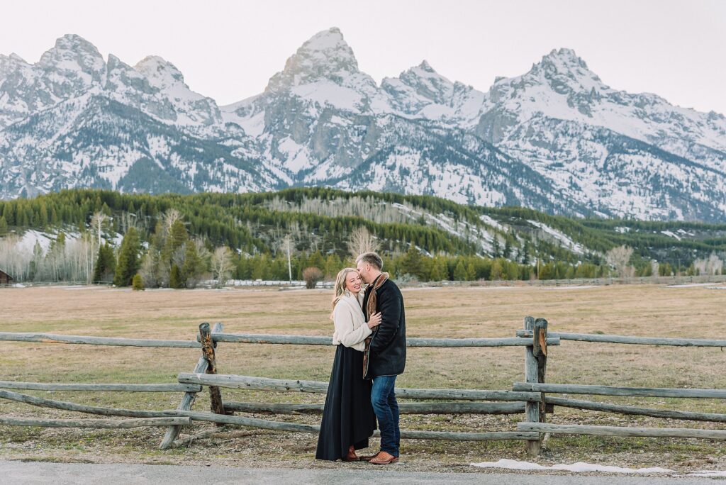 Grand Teton couples anniversary photos spring session Wyoming mountain bridge waterfall couple portraits Luxury western couples photography Jackson Hole Early season mountain engagement photos Tetons