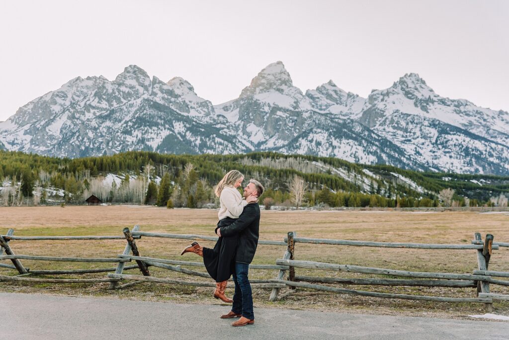 Grand Teton couples anniversary photos spring session Wyoming mountain bridge waterfall couple portraits Luxury western couples photography Jackson Hole Early season mountain engagement photos Tetons