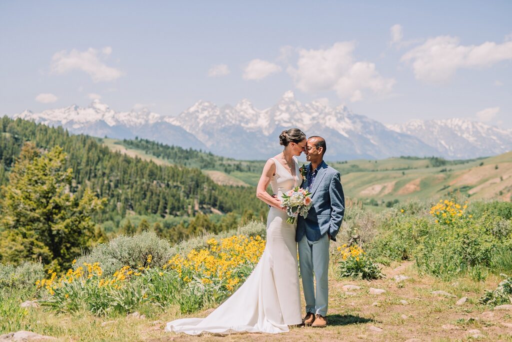 intimate Jackson Hole wedding photography The Wedding Tree ceremony photos Wyoming Wyoming mountain elopement at Wedding Tree June wildflower wedding ceremony Grand Tetons Wedding Tree elopement photographer Grand Teton National Park wildflower bouquet mountain wedding photography