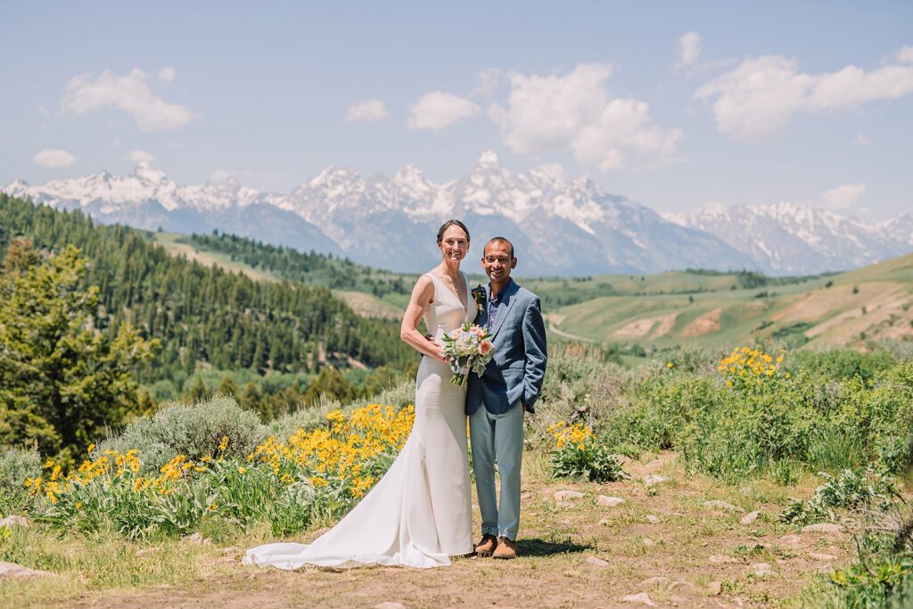 intimate Jackson Hole wedding photography The Wedding Tree ceremony photos Wyoming Wyoming mountain elopement at Wedding Tree June wildflower wedding ceremony Grand Tetons Wedding Tree elopement photographer Grand Teton National Park wildflower bouquet mountain wedding photography