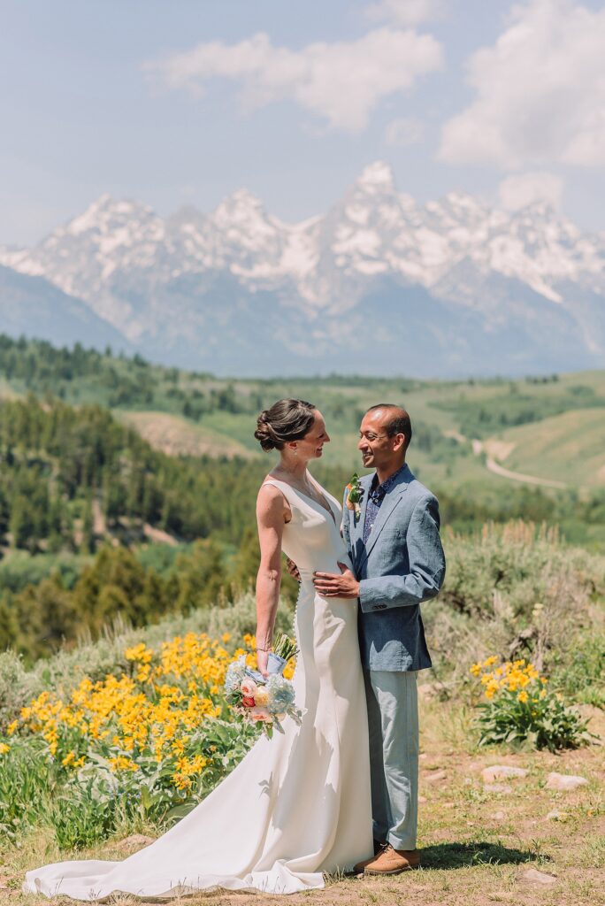 intimate Jackson Hole wedding photography The Wedding Tree ceremony photos Wyoming Wyoming mountain elopement at Wedding Tree June wildflower wedding ceremony Grand Tetons Wedding Tree elopement photographer Grand Teton National Park wildflower bouquet mountain wedding photography
