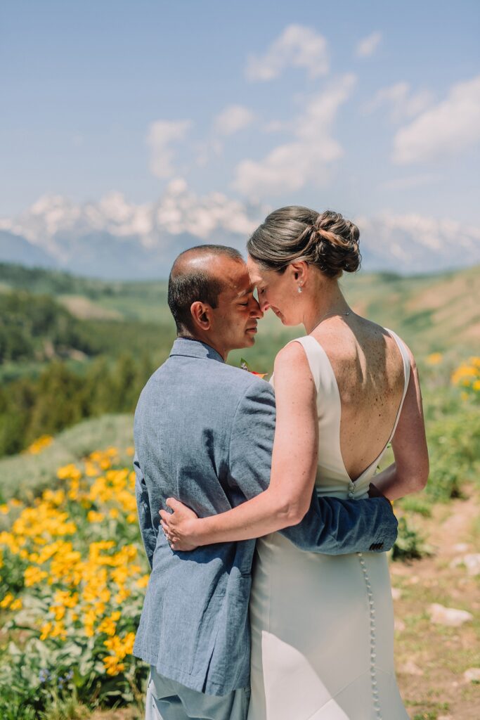 intimate Jackson Hole wedding photography The Wedding Tree ceremony photos Wyoming Wyoming mountain elopement at Wedding Tree June wildflower wedding ceremony Grand Tetons Wedding Tree elopement photographer Grand Teton National Park wildflower bouquet mountain wedding photography