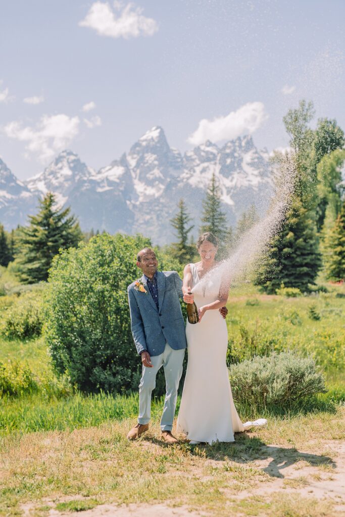 intimate elopement photography Schwabacher Landing champagne toast at Wyoming elopement personalized coffee mug elopement surprise mountain wedding with snow capped Teton peaks Jackson Hole destination wedding photographer Grand Teton elopement photography session