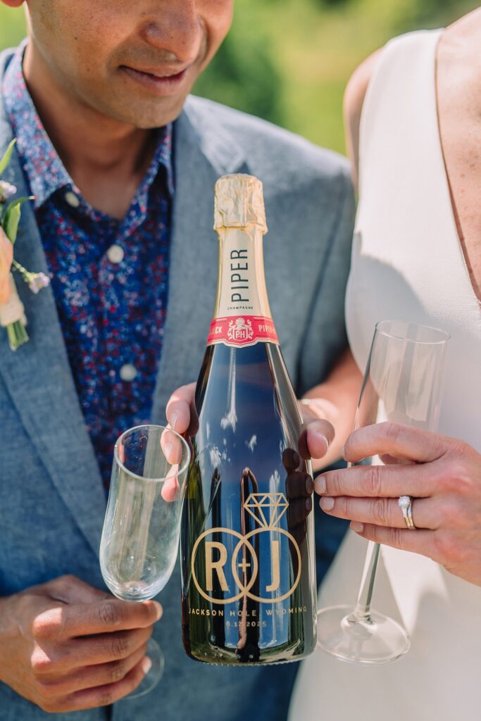 intimate elopement photography Schwabacher Landing champagne toast at Wyoming elopement personalized coffee mug elopement surprise mountain wedding with snow capped Teton peaks Jackson Hole destination wedding photographer Grand Teton elopement photography session