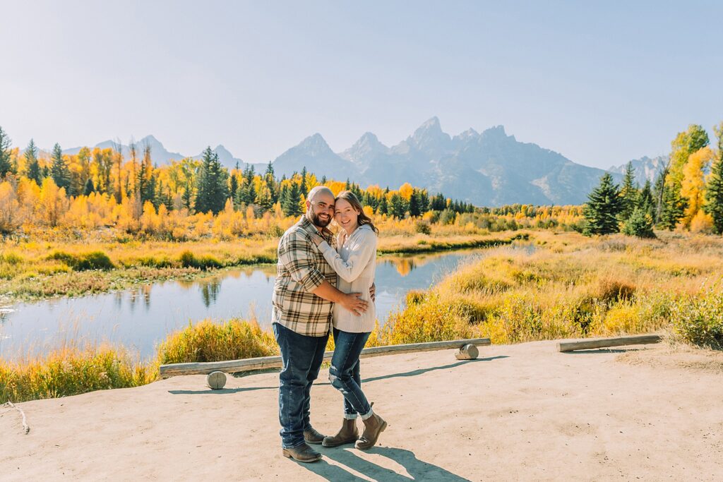 Teton mountain engagement photography with fall colors Schwabacher Landing engagement session autumn Casual mountain engagement photos with jeans Fall engagement session Grand Tetons Wyoming Cream sweater engagement photos mountain backdrop
